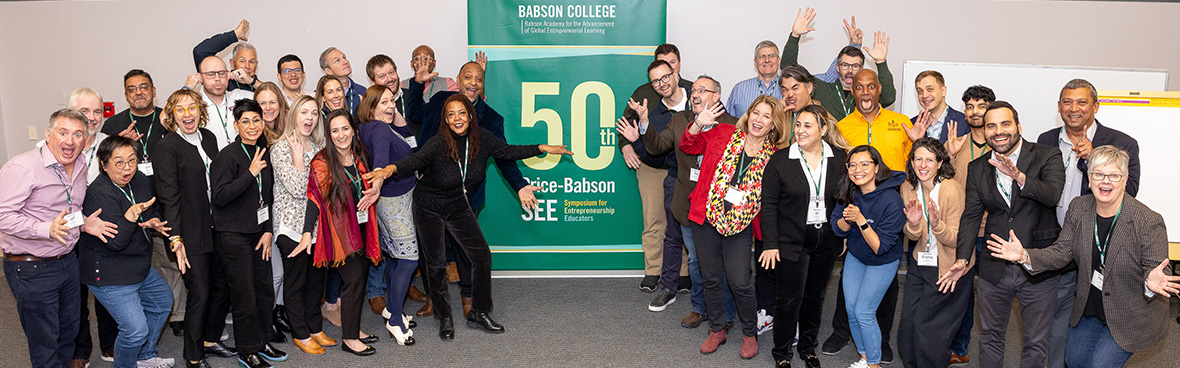 a group of happy people in front of Babson Academy sign