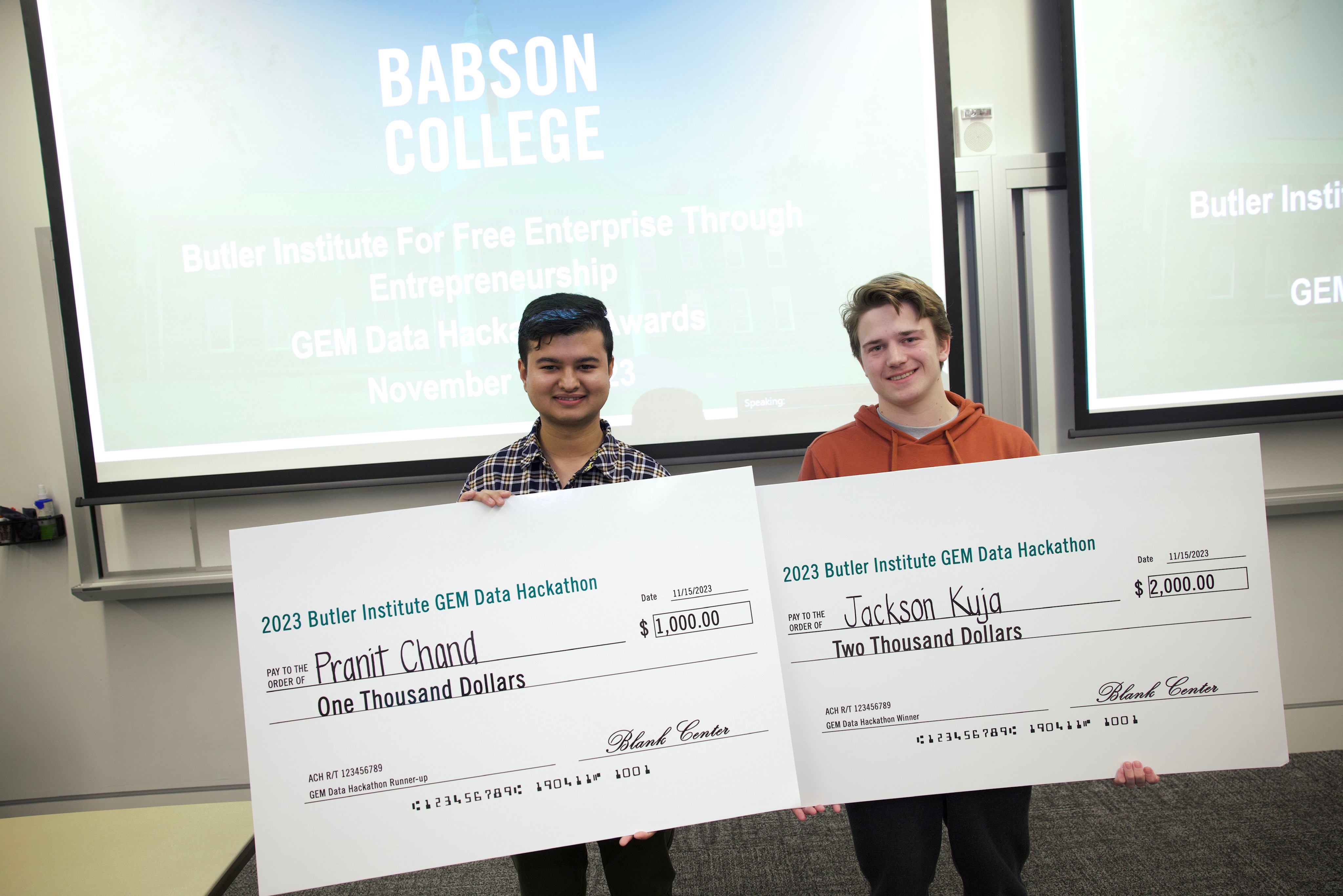 Jackson and Pranit holding checks