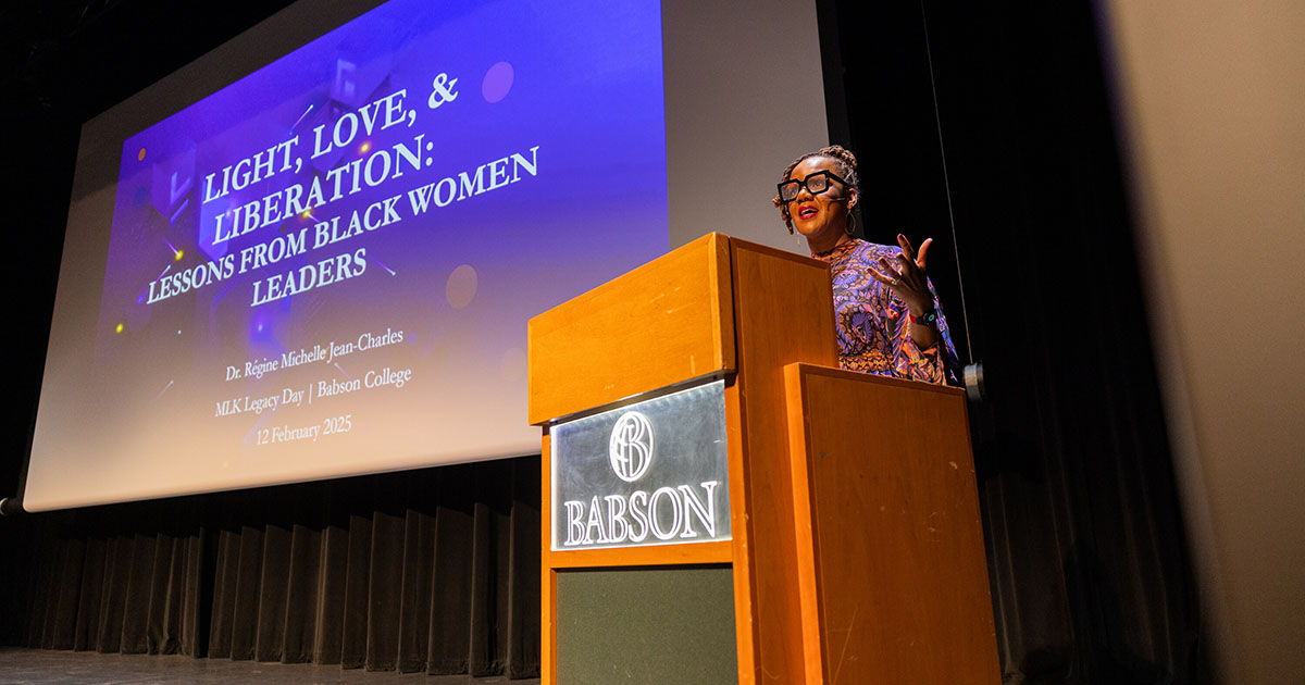 Dr. Regine Jean-Charles speaking at a lectern.