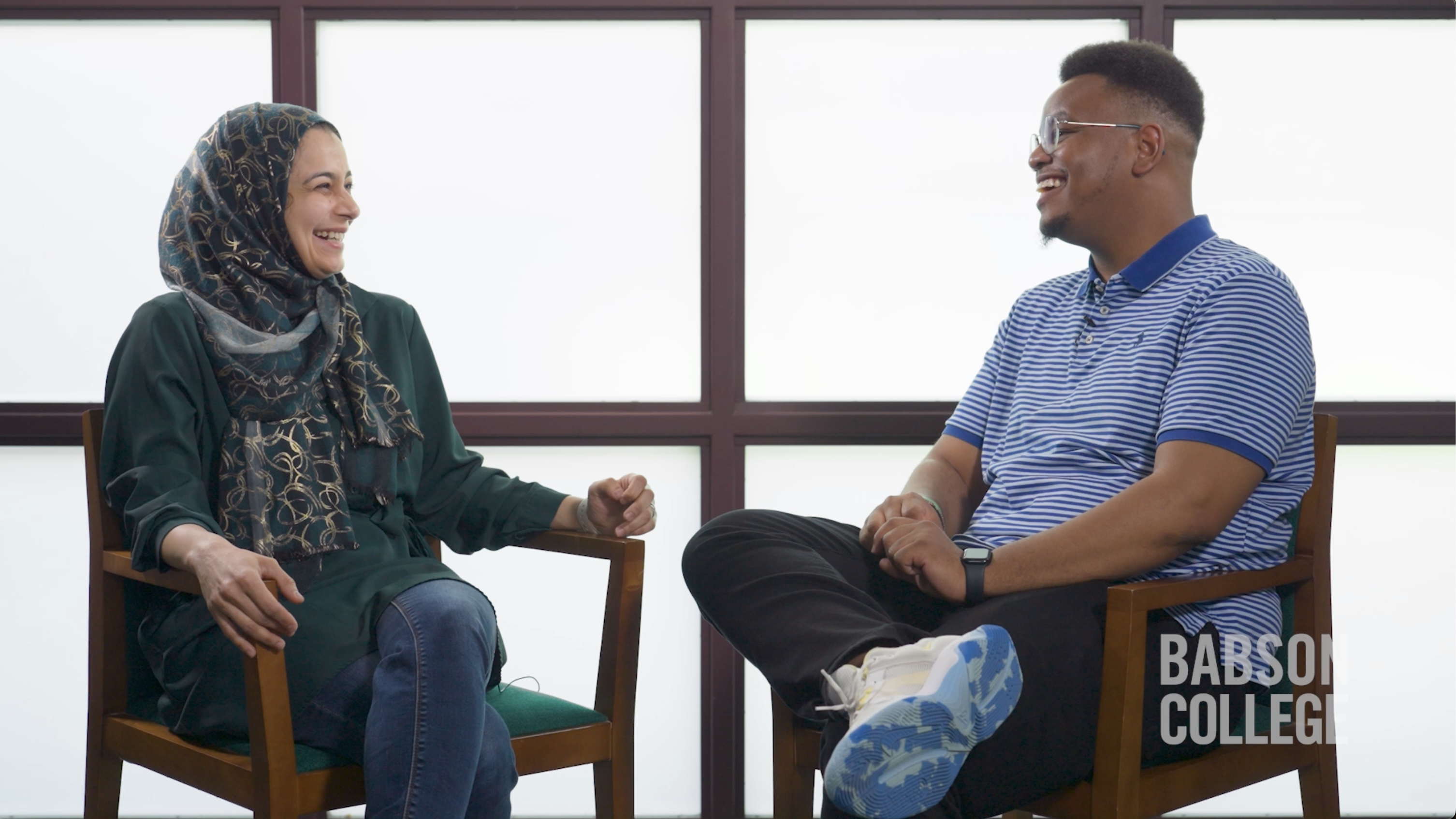 professor and student laughing and talking