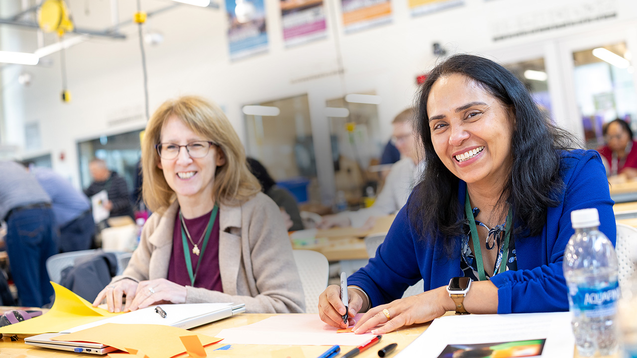two students smiling at camera