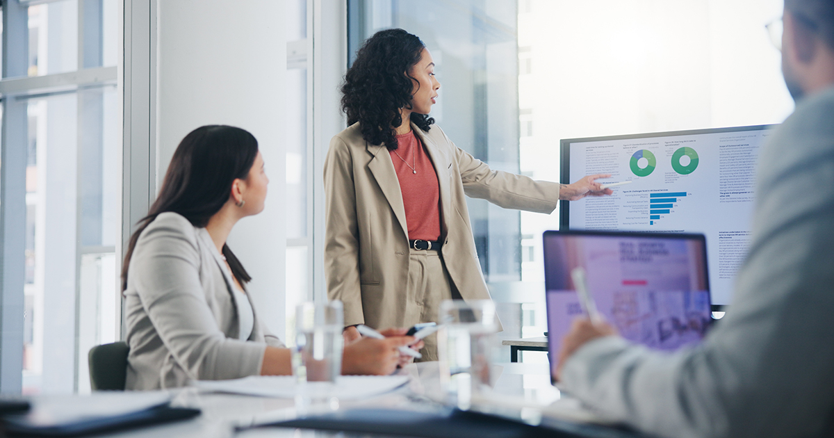 One person giving a presentation to two other people