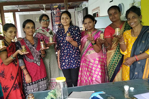 Sonal Dalvi MBA’23 poses for a portrait with a group of women artists