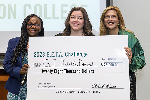 Three women holding giant check during the 2023 BETA Challenge