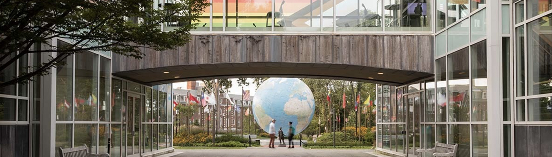 students talking in the distance in front of babson globe