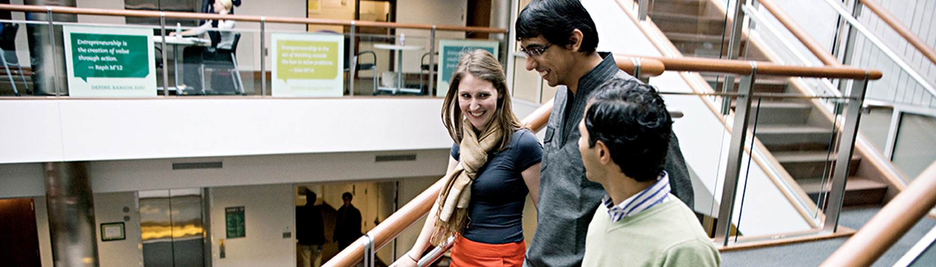 Group of three people descending stairs in Olin