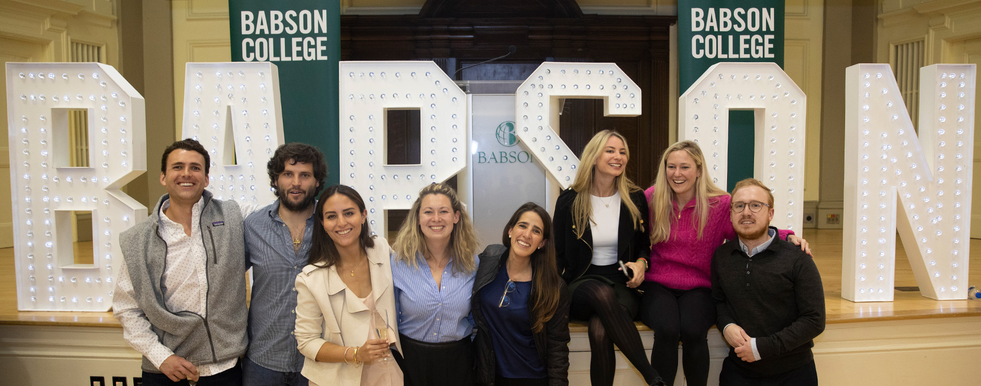 Students in front of Babson signage