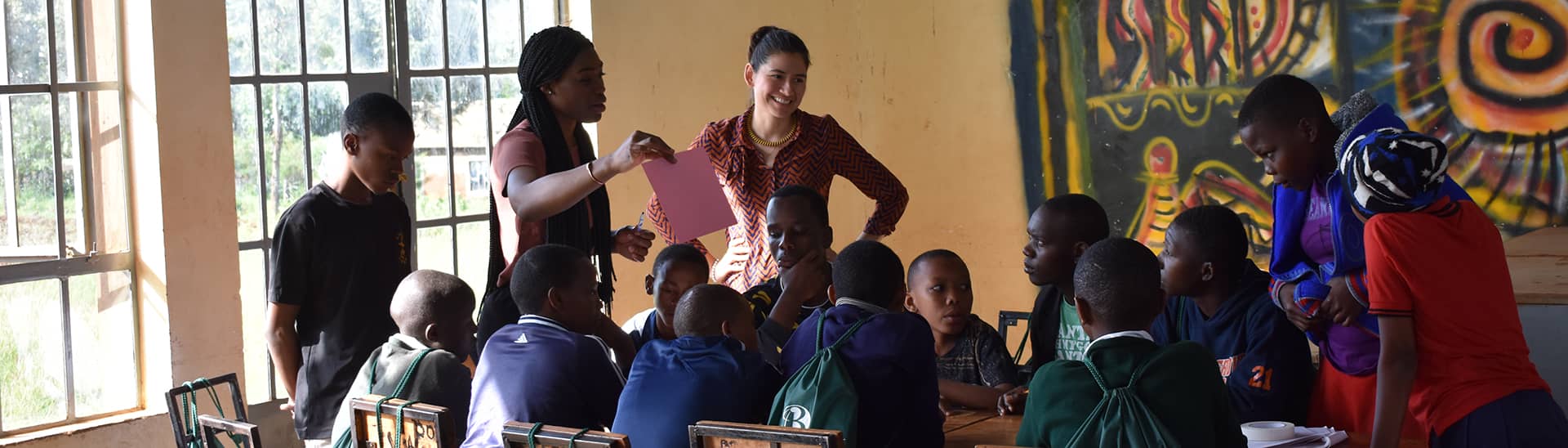 students teaching Tanzanian youth