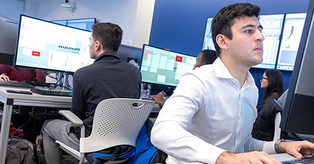 A student at a computer in the trading room