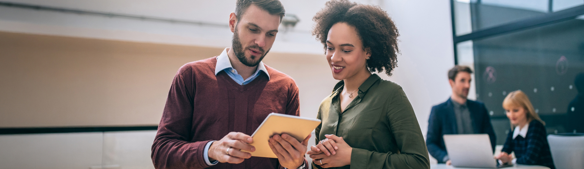 Two people looking at a printed piece of paper together