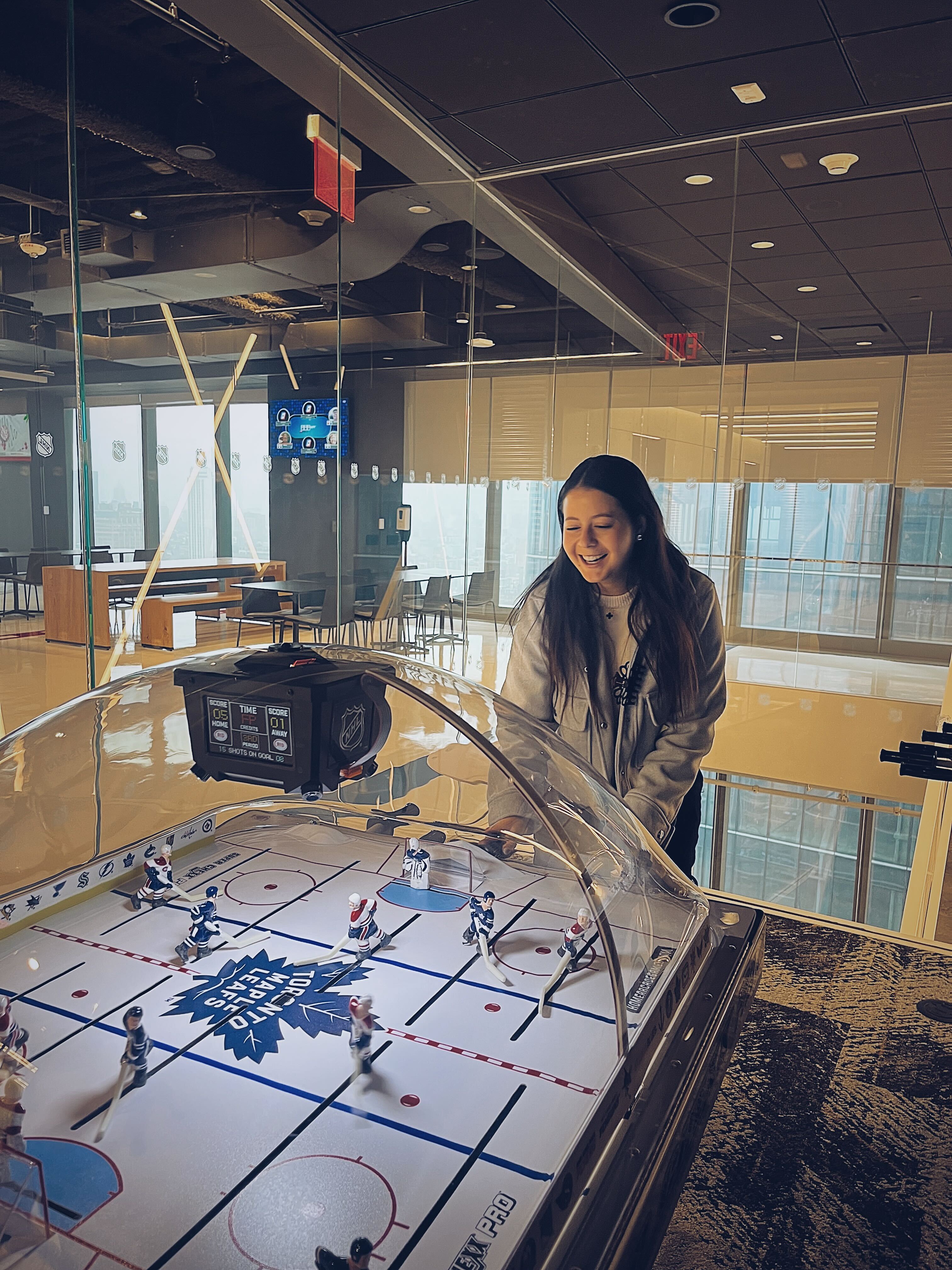 A woman playing table hockey